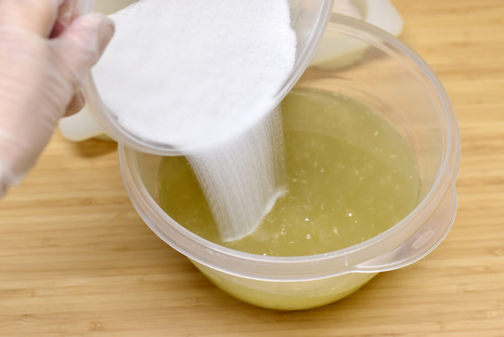 fine sea salt being added to prepared soapmaking oils